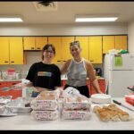 Two women serving food